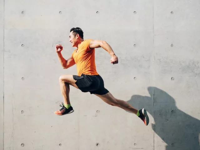 Sporty man jumping in the air to illustrate the best vitamins for energy