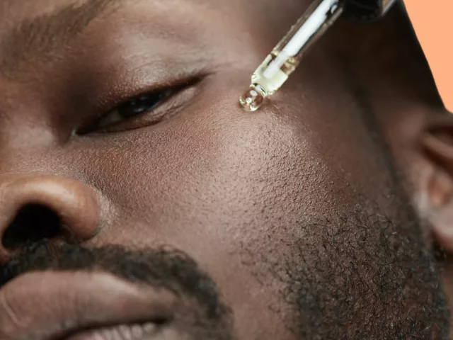 Man applying vitamin C serum to benefit his skin