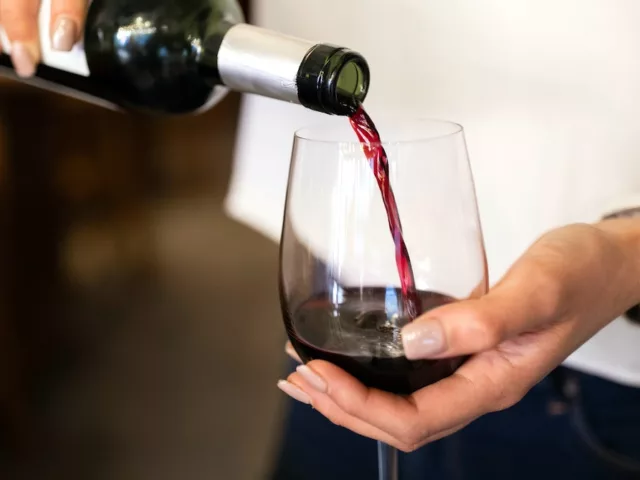 Woman pouring a glass of natural wine