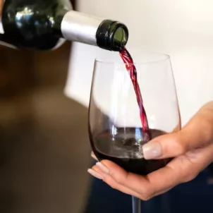 Woman pouring a glass of natural wine