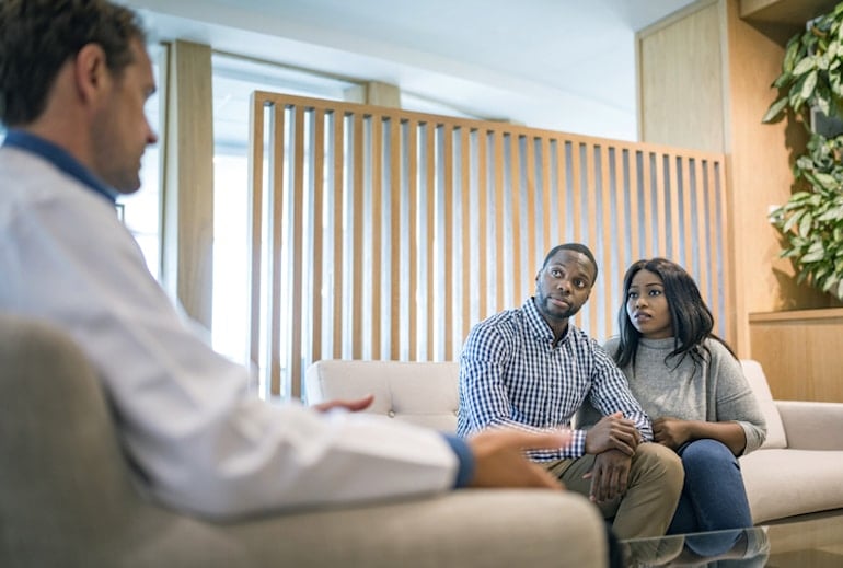 Young couple at doctor's visit to discuss the causes of hormonal imbalance