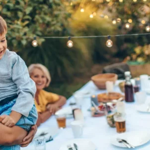 Multigenerational family eating dinner outside to illustrate how your nutritional needs change over time and by age group