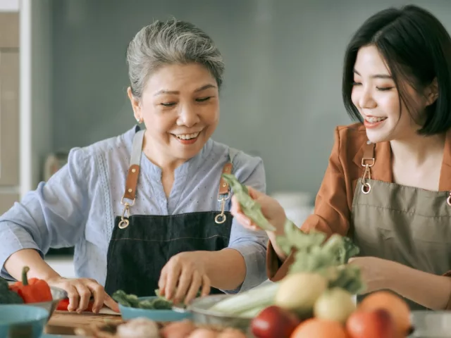 Asian mother and daughter cooking at home toether