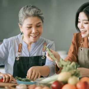 Asian mother and daughter cooking at home toether