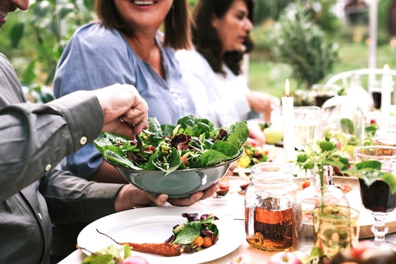 Friends having dinner outdoors on a plant-based diet