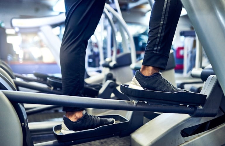 Man on elliptical machine to protect immunity via exercise