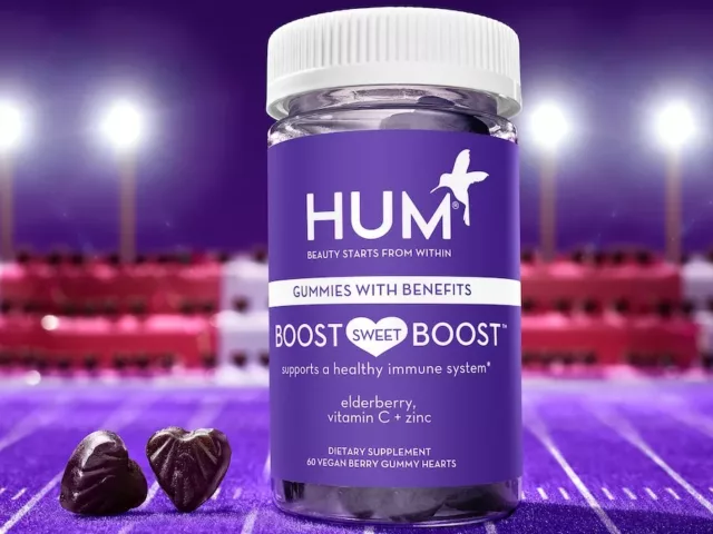 HUM Boost Sweet Boost immunity gummies on a purple football field