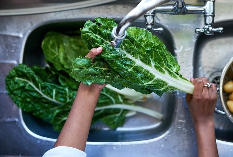 Immunologist Dr. Payel Gupta washing spinach to add to her egg breakfast