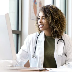 Healthy doctor on the computer; concept for how doctors boost their immunity to stay healthy