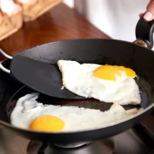 Immunologist cooking sunny side up eggs for breakfast to maintain immune health