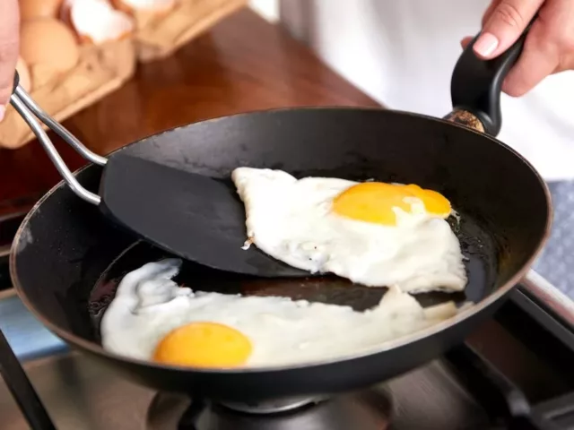 Immunologist cooking sunny side up eggs for breakfast to maintain immune health