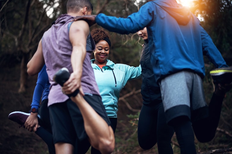 Group of friends stretching on a hike