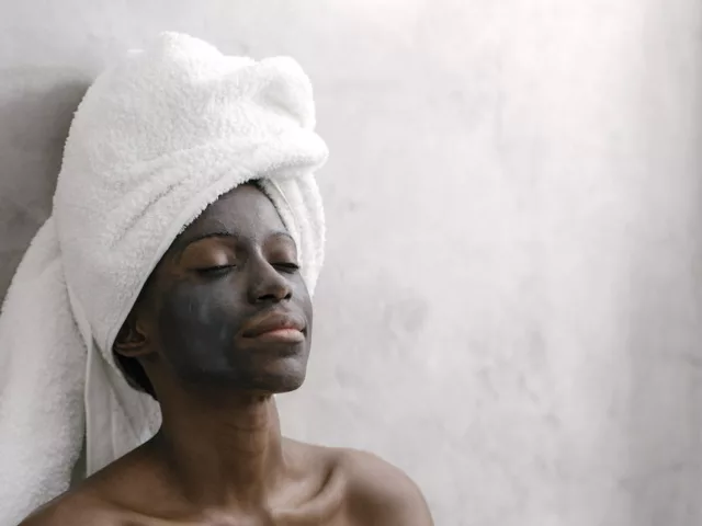Woman relaxing while benefiting from activated charcoal skincare products