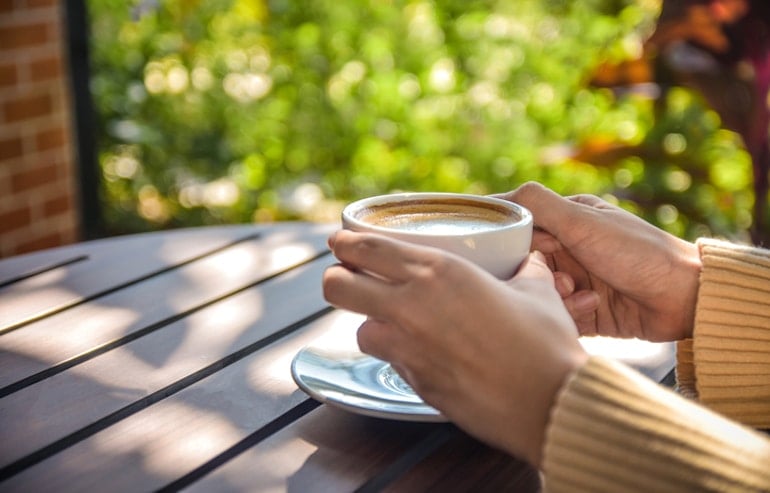 Woman taking her latte outdoors in the morning