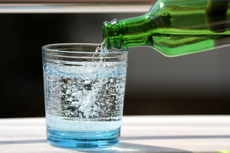 Pouring seltzer into glass