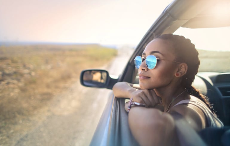 Woman with braids looking out of car window