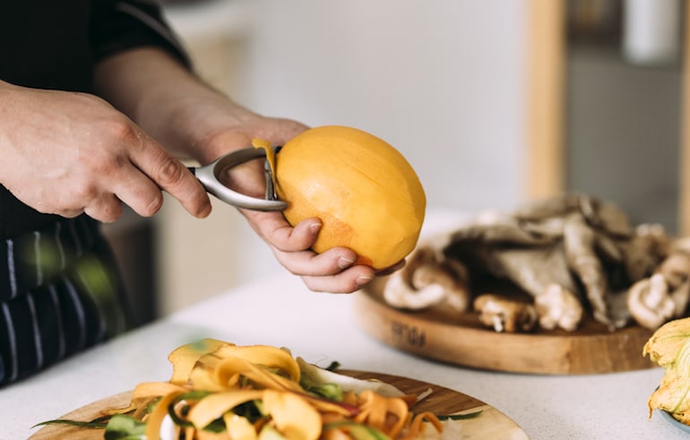 Man peeling mango to eat for its health benefits