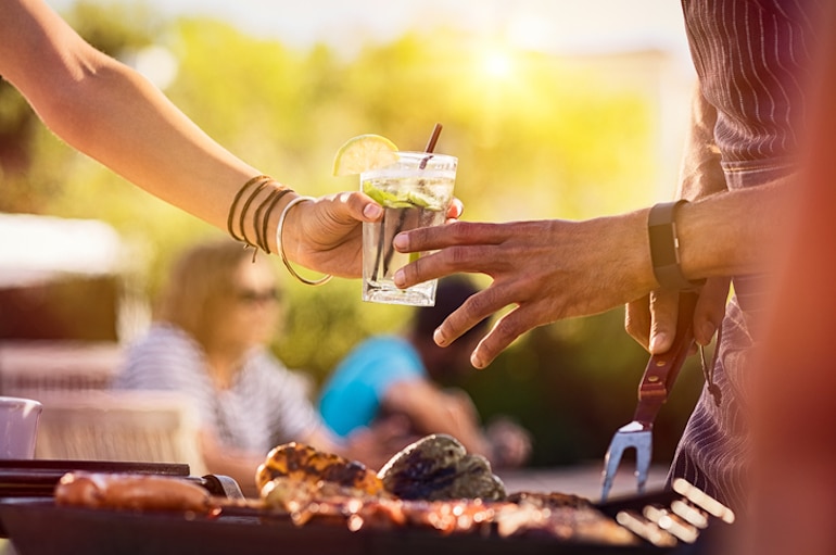 Friends sharing alcoholic spiked seltzer at a barbeque