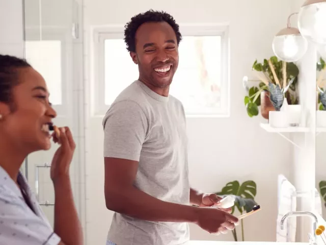 Couple brushing their teeth to prevent stains and yelllowing