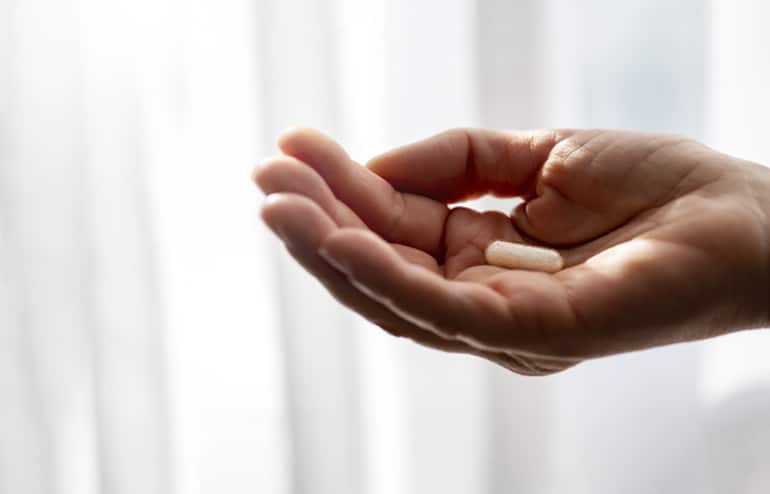 Woman's hand holding a collagen supplement