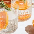 Healthiest hard seltzer in glasses with citrus fruits