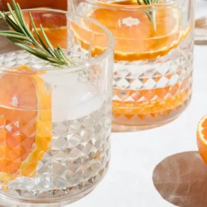 Healthiest hard seltzer in glasses with citrus fruits