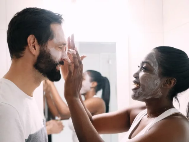 Couple applying microdermabrasion treatments to benefit their skin