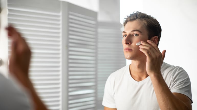 Man applying topical probiotic moisturizing cream