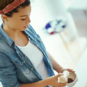 woman making herbal blend