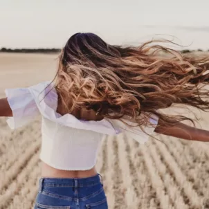 girl with long hair in field