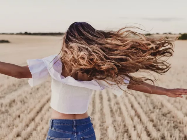 girl with long hair in field