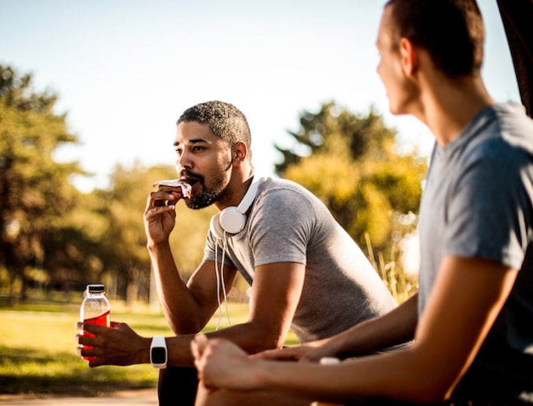 man eating protein bar