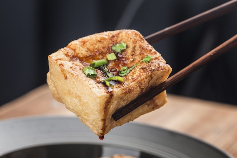 tofu with chopsticks