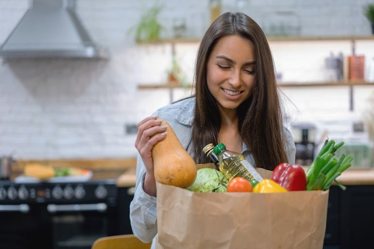 Woman emptying grocery bag