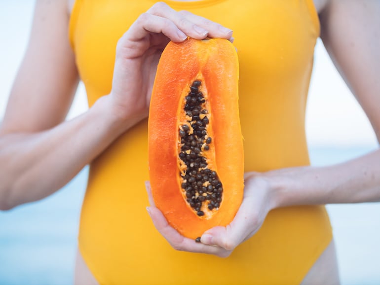 woman holding papaya