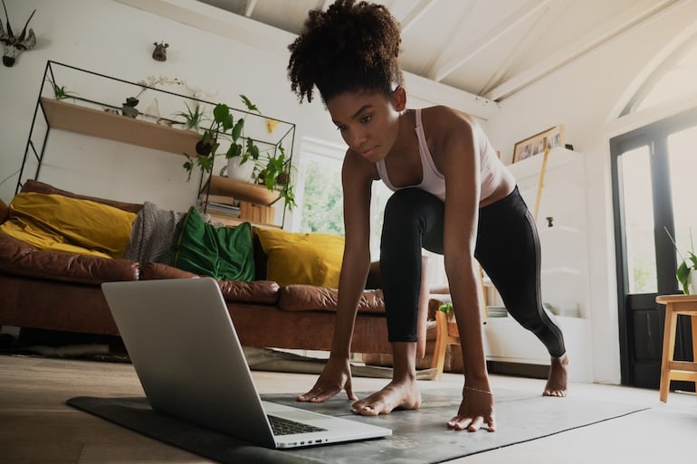 woman stretching over video