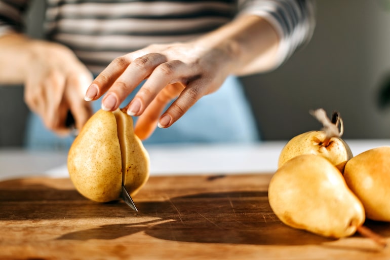 woman cutting pears