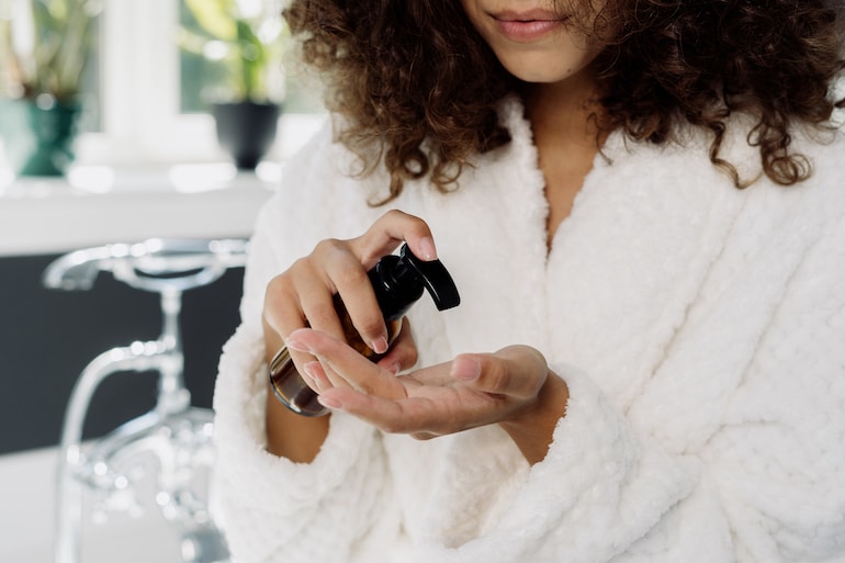 woman applying moisturizer