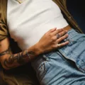 Woman with bad gut health laying on couch touching her stomach