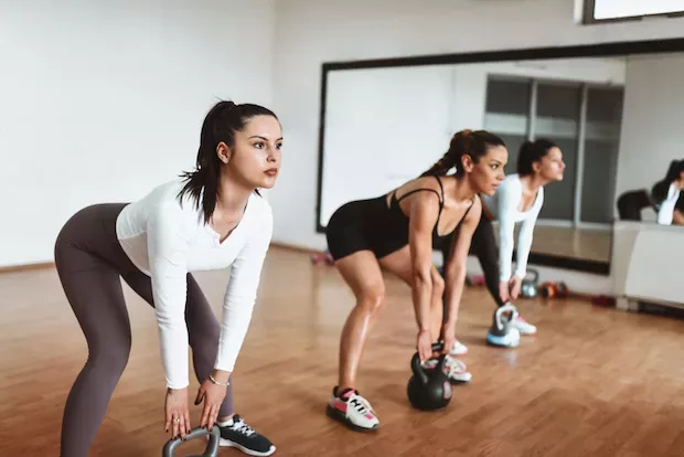 Women in a HIIT workout class to boost metabolism, burn calories, and lose weight