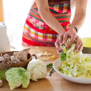 Woman preparing fermented food to promote gut health and weight loss