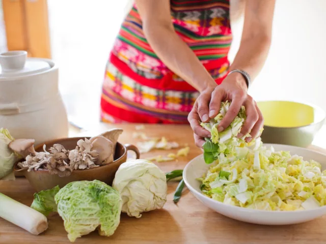 Woman preparing fermented food to promote gut health and weight loss