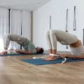 Man and woman doing bridge pose to strengthen pelvic floor muscles