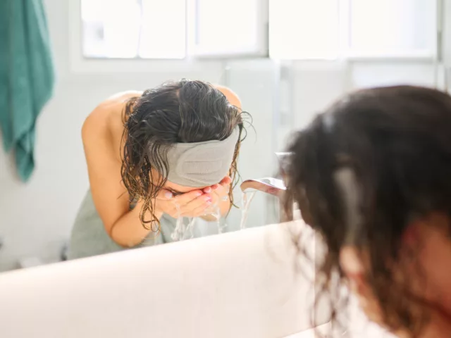 Woman washing face with gentle cleanser to embrace skinimalism