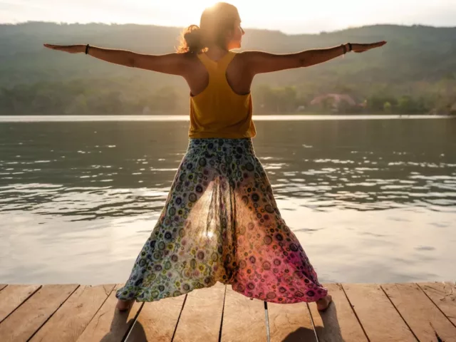 Woman doing yoga as part of her cycle syncing exercise routine