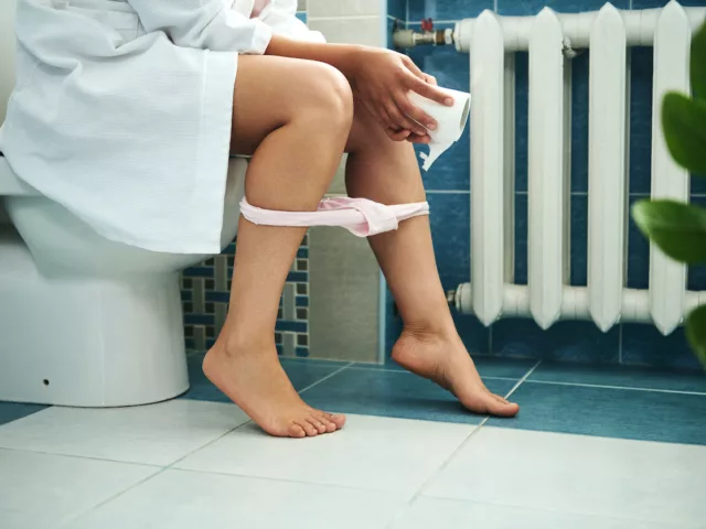 Woman on toilet having a morning poop