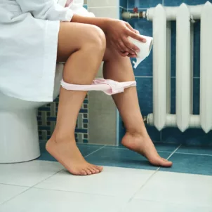 Woman on toilet having a morning poop