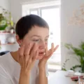 Woman looking at her retinol purge in the mirror