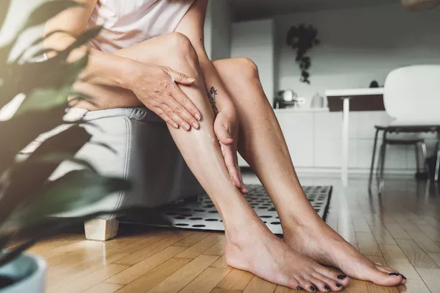 Woman applying lotion with ceramides to get rid of KP