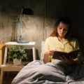 Woman reading in bed as part of her bedtime routine